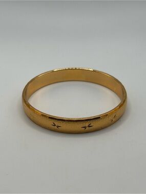 Vintage Monet gold plate bangle with diamond cut detailing 7”